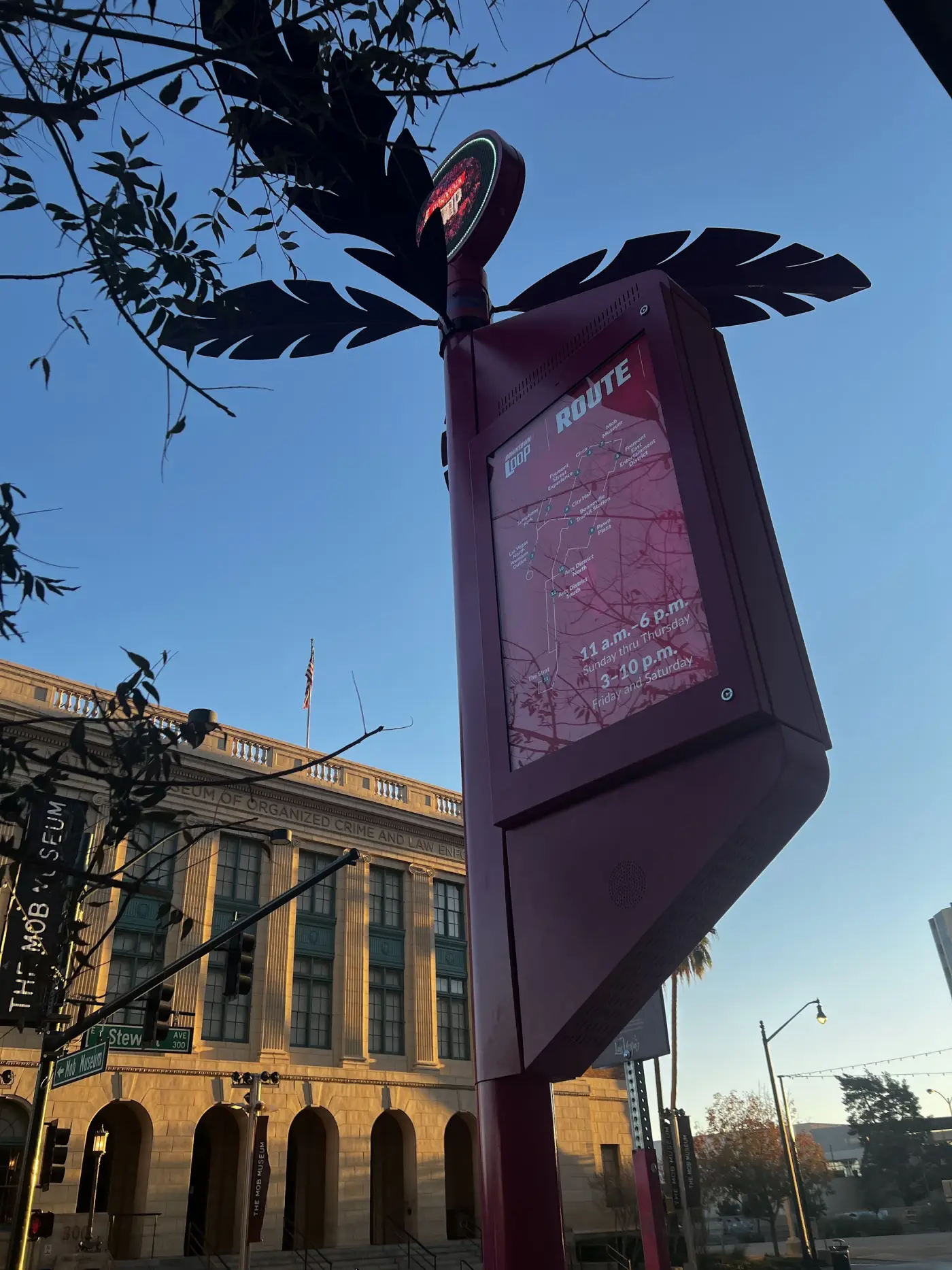 A pole-mounted route-map display in a decorative downtown enclosure.