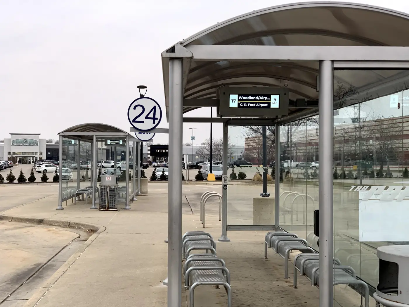 Two glass bus shelters each fitted with a compact arrivals display